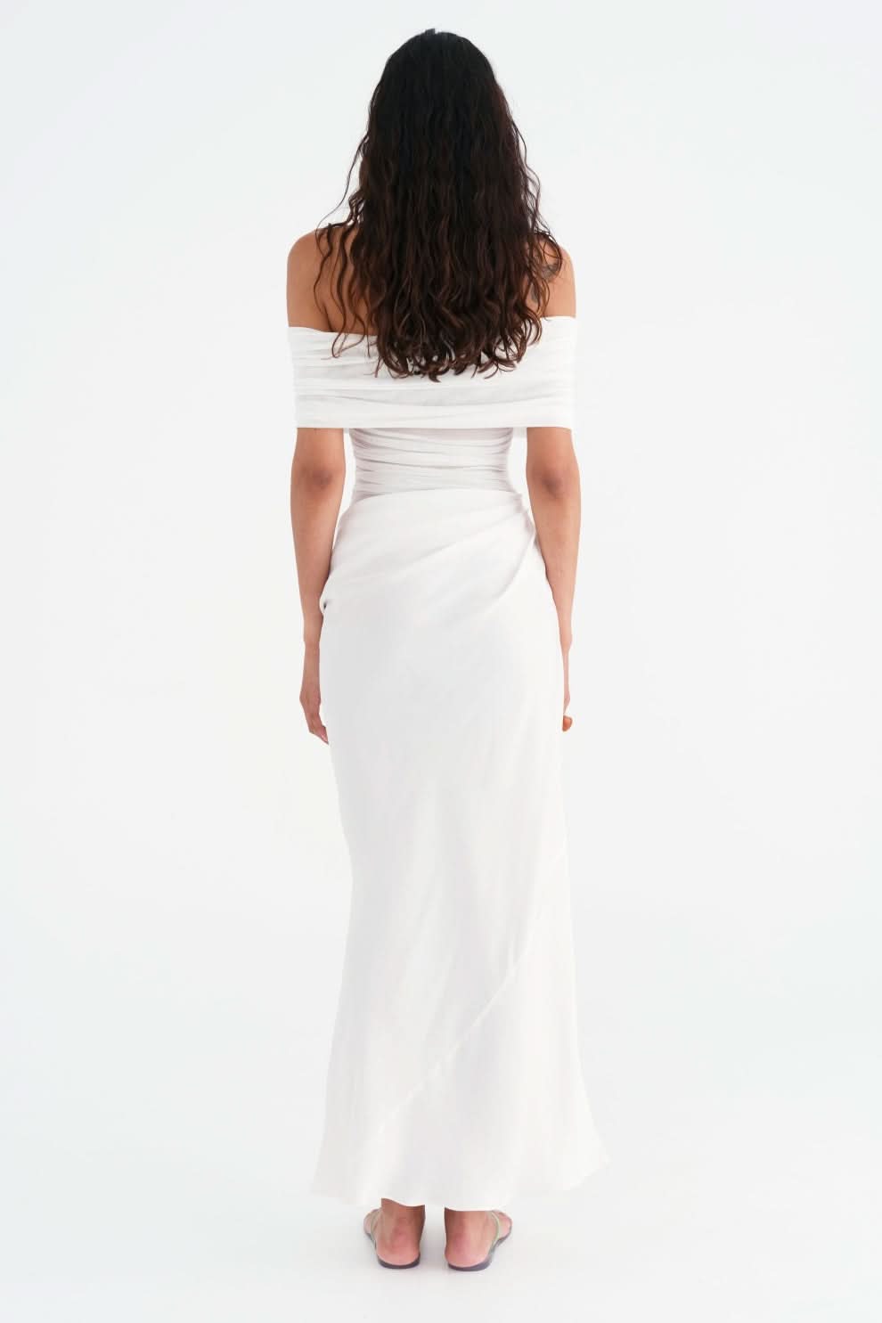 White off-shoulder maxi dress with ruched waist and draped skirt, back view