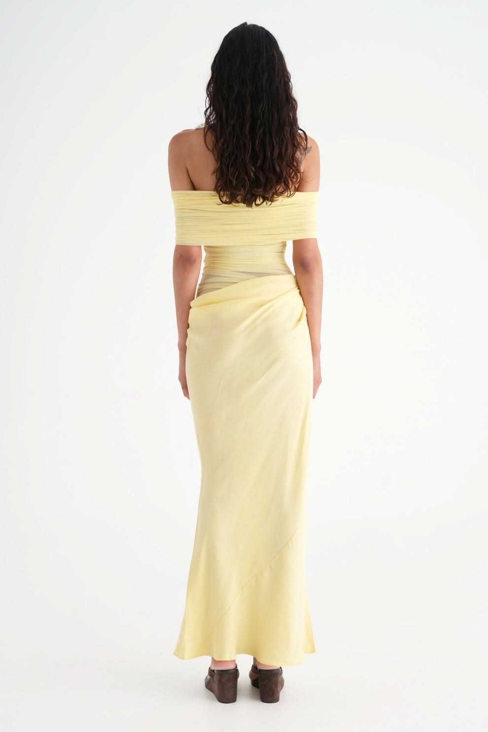 Back view of yellow maxi dress with off-shoulder neckline and draped skirt