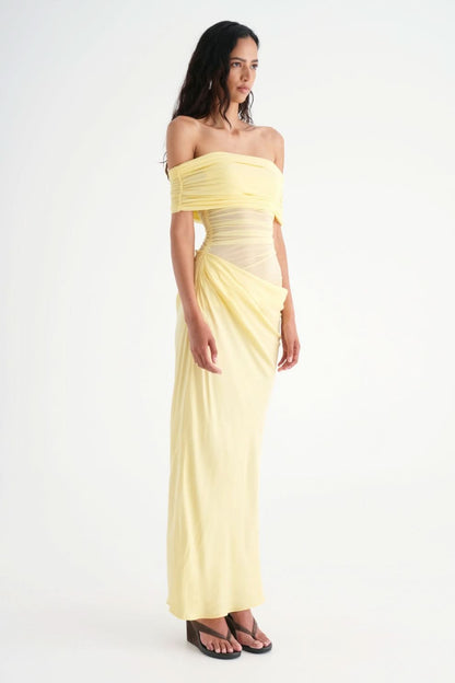 Side profile of yellow off-shoulder maxi dress with ruched waist
