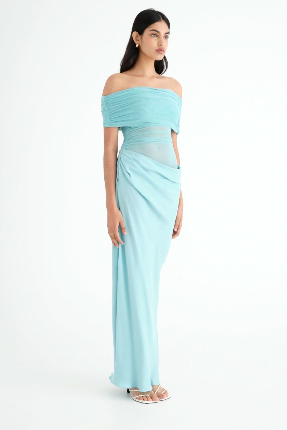 Side view of turquoise maxi dress with off-shoulder neckline and wrap skirt