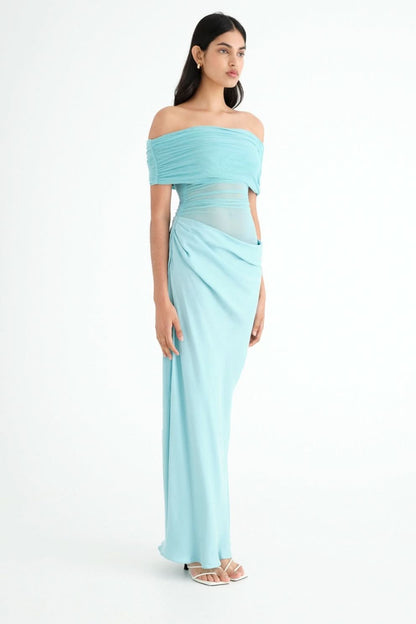 Side view of turquoise maxi dress with off-shoulder neckline and wrap skirt