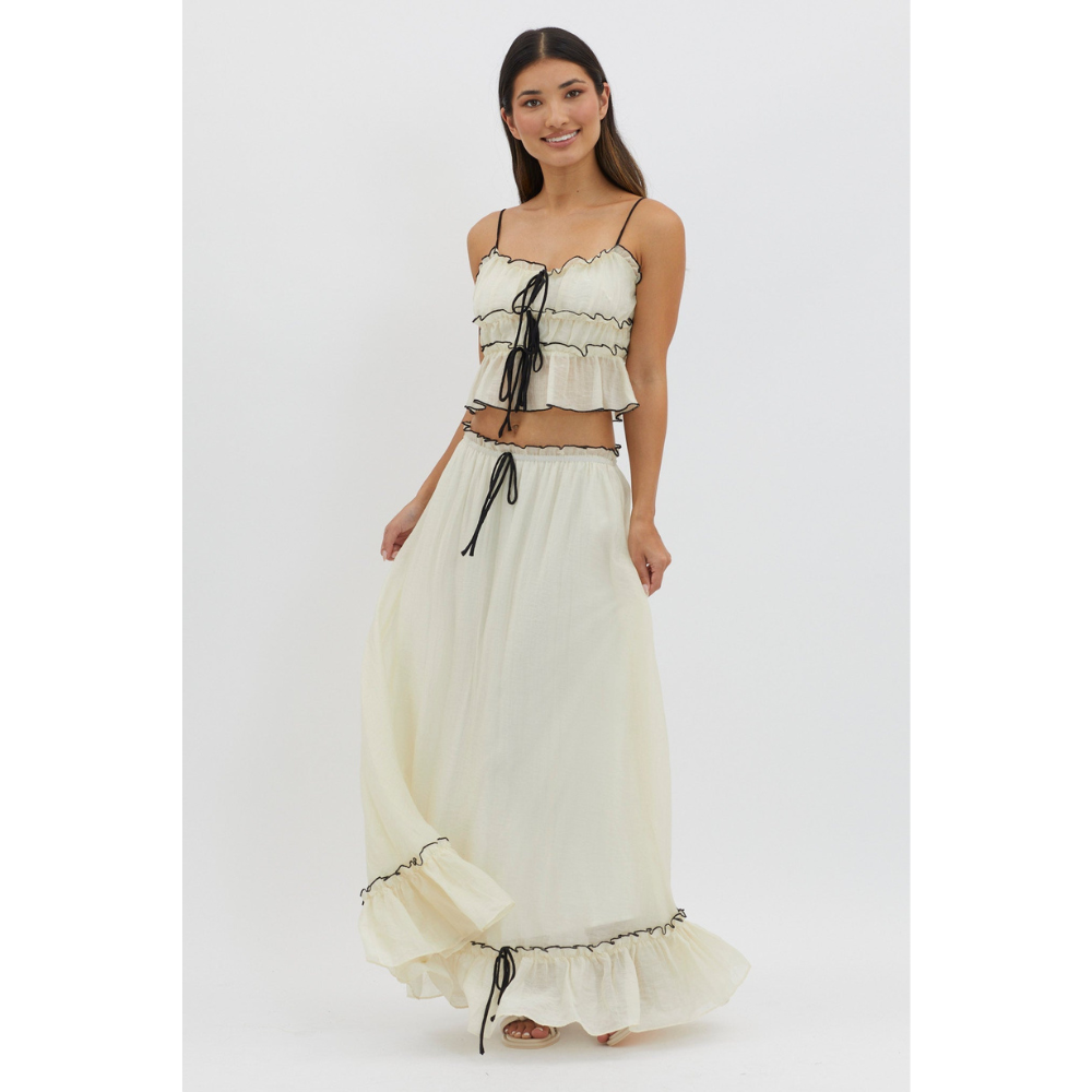 Cream two-piece maxi skirt set with ruched crop top and flowing skirt with ruffled hem