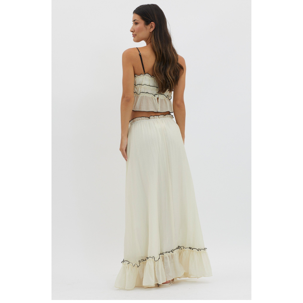 Back view of cream maxi skirt set with spaghetti straps and ruffled hem detail