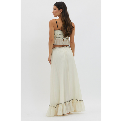 Back view of cream maxi skirt set with spaghetti straps and ruffled hem detail