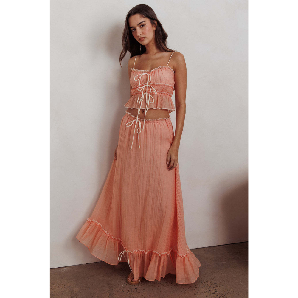Coral pink maxi skirt set with pleated fabric and white drawstring ties throughout