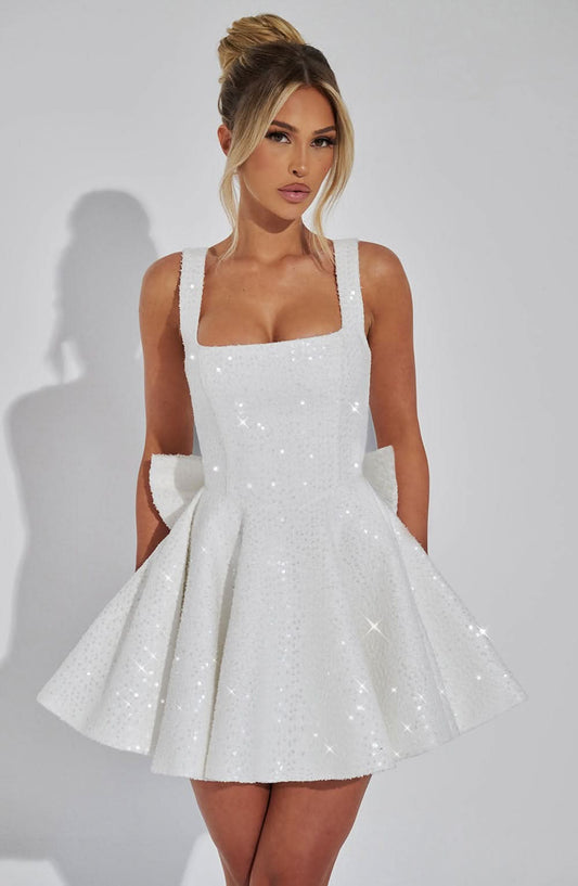 White sequin mini dress with square neckline and full skirt with pockets