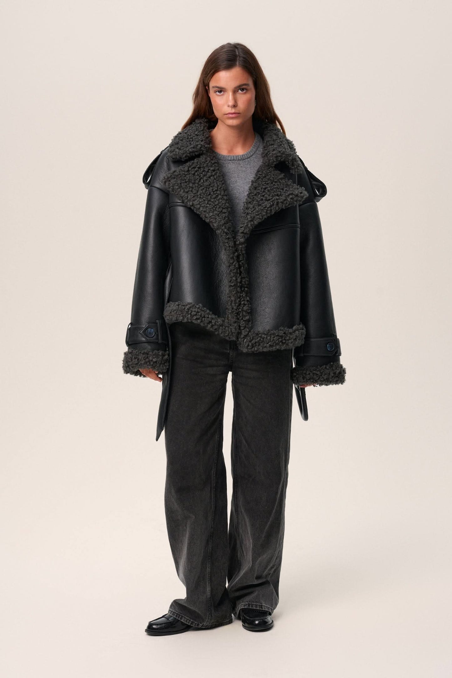 Black leather cropped coat with oversized charcoal fleece collar, open front view