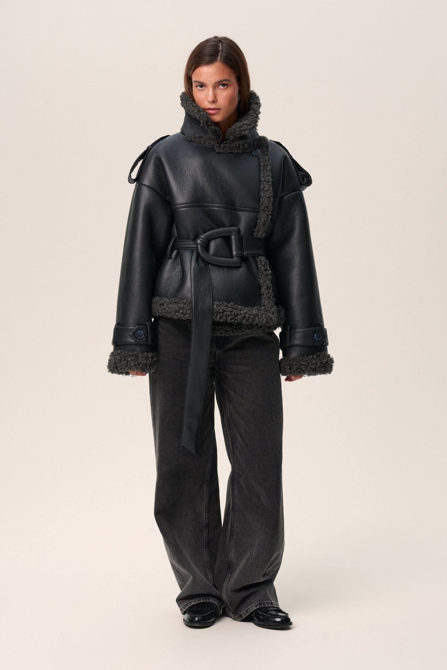 Black leather cropped coat with charcoal fleece trim and tie-neck detail, front