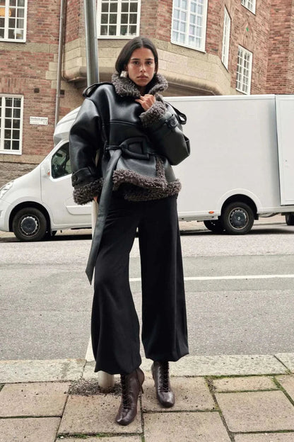 Black leather cropped coat with charcoal fleece trim worn with dark denim, street style