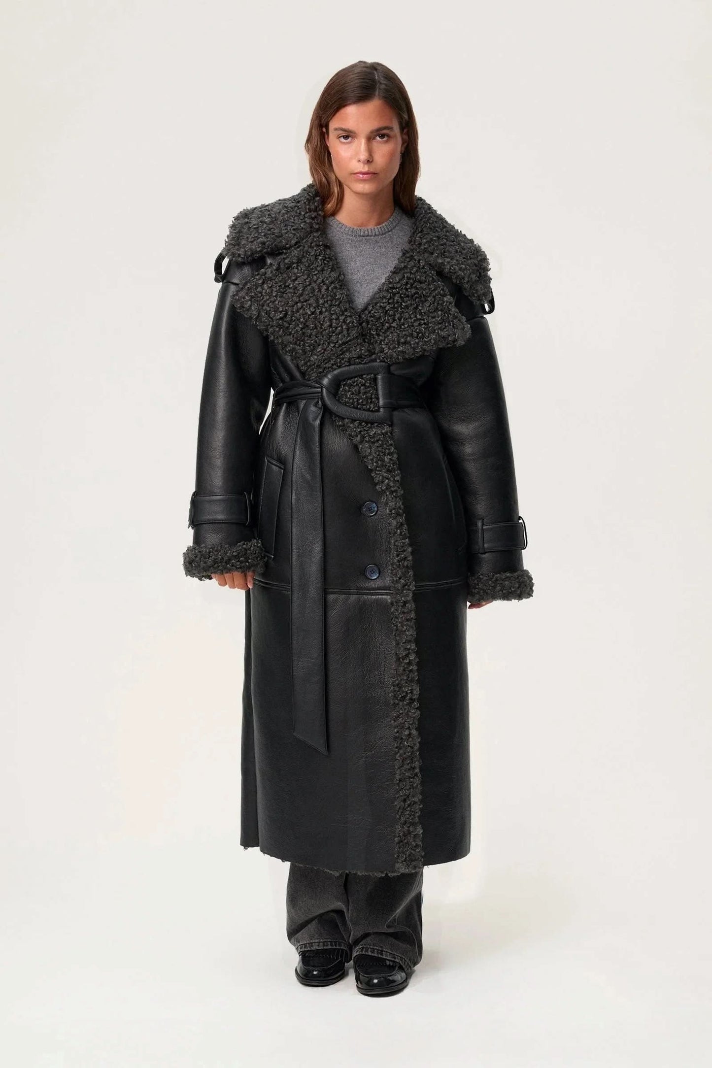 Black leather cropped coat with wide charcoal fleece collar and button front closure