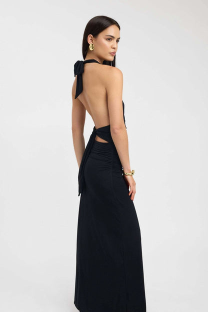 Side view of black maxi dress with open back and tied halter closure