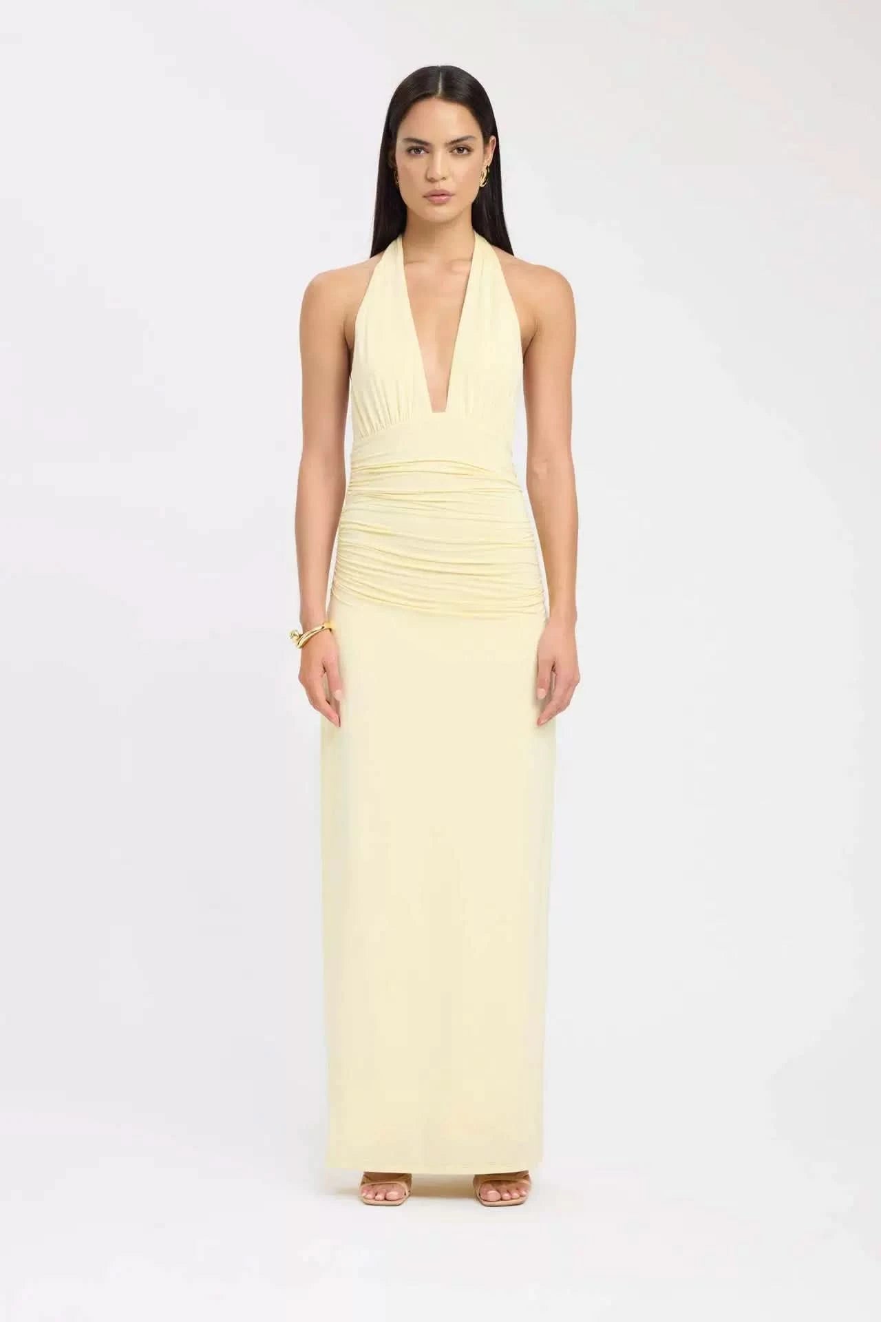 Pale yellow halter maxi dress with V-neckline and ruched bodice