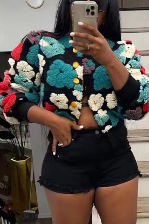 Black flower jacket with teal, pink, cream, and yellow dimensional puffed blooms