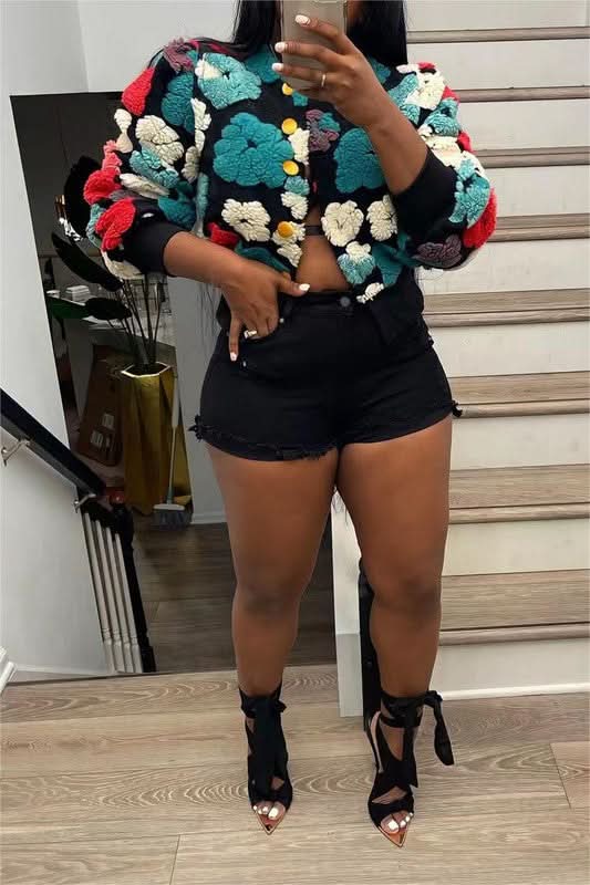 Black flower jacket with teal, red, cream, and yellow textured floral appliqués