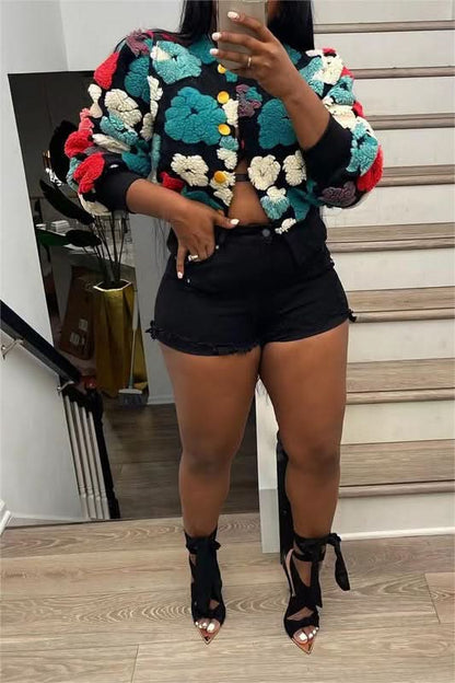 Black flower jacket with teal, red, cream, and yellow textured floral appliqués