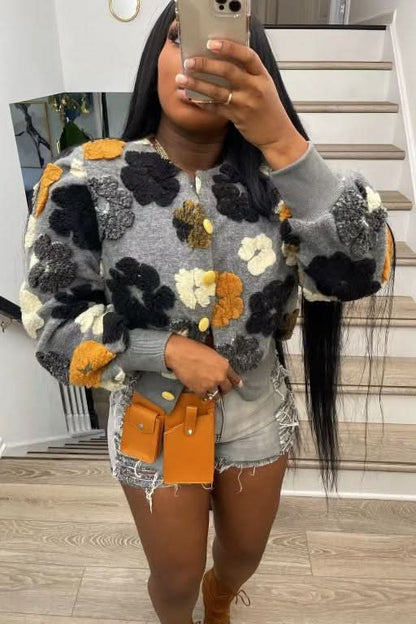Gray flower jacket with black, orange, cream, and yellow dimensional puffed flowers