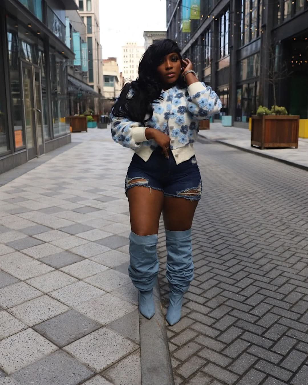 White flower jacket with blue and cream daisy print on urban street background