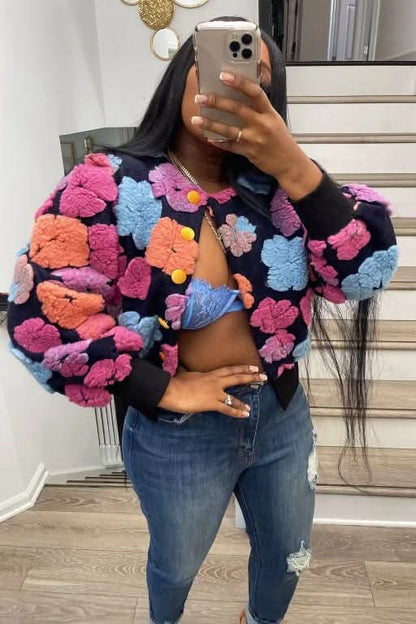 Textured flower jacket with pink, blue, orange, and yellow puffed blooms on black background