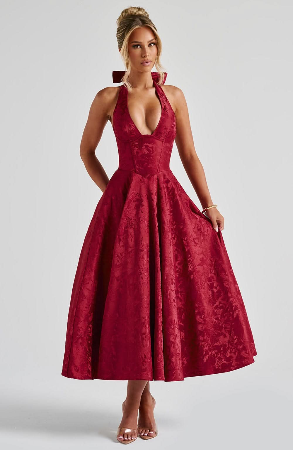 Burgundy velvet halter midi dress with structured bodice and voluminous skirt