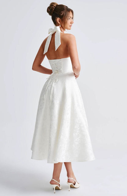 Back view of cream midi dress with lace-up corset and bow tie detail