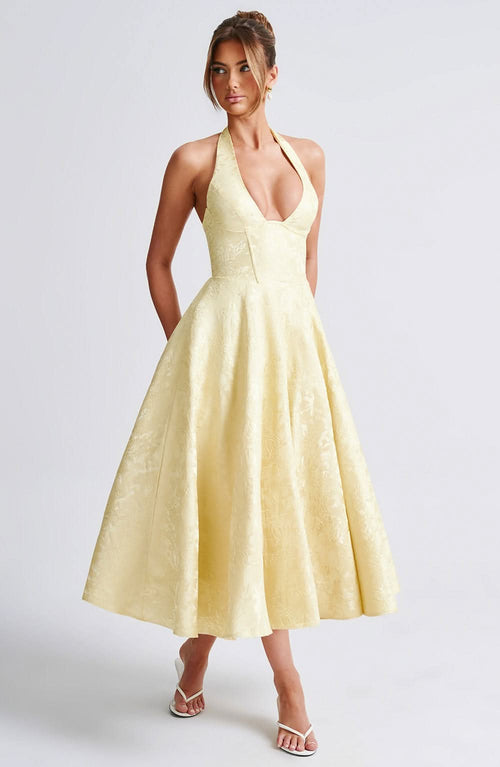 Pale yellow halter midi dress with full skirt and fitted bodice