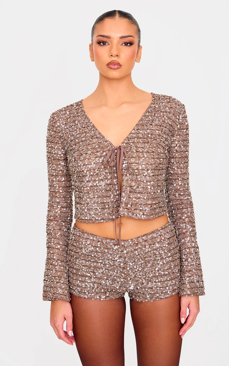 Close-up of taupe sequin tie-front detail on cropped evening set