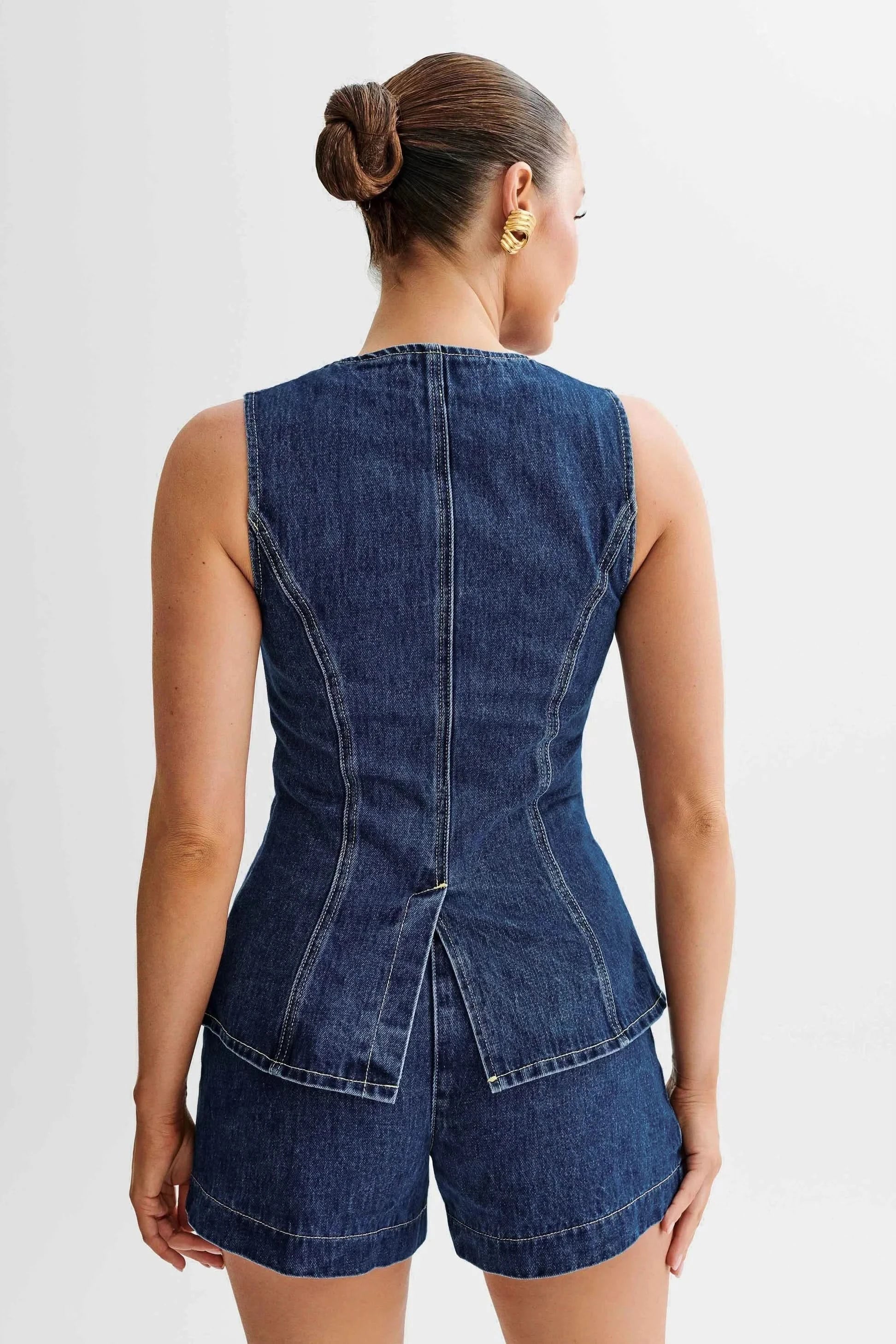 Back view of sleeveless denim vest with center seam detail