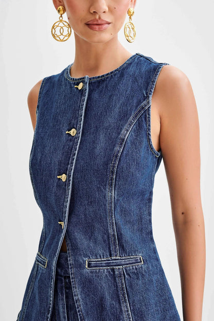 Close-up of denim vest front with gold button hardware detail