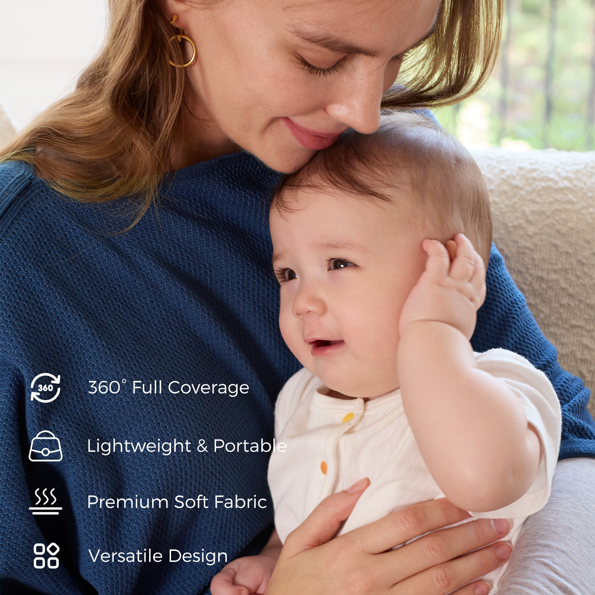 Mother wearing navy nursing cover holding baby with 360 coverage and lightweight portable design