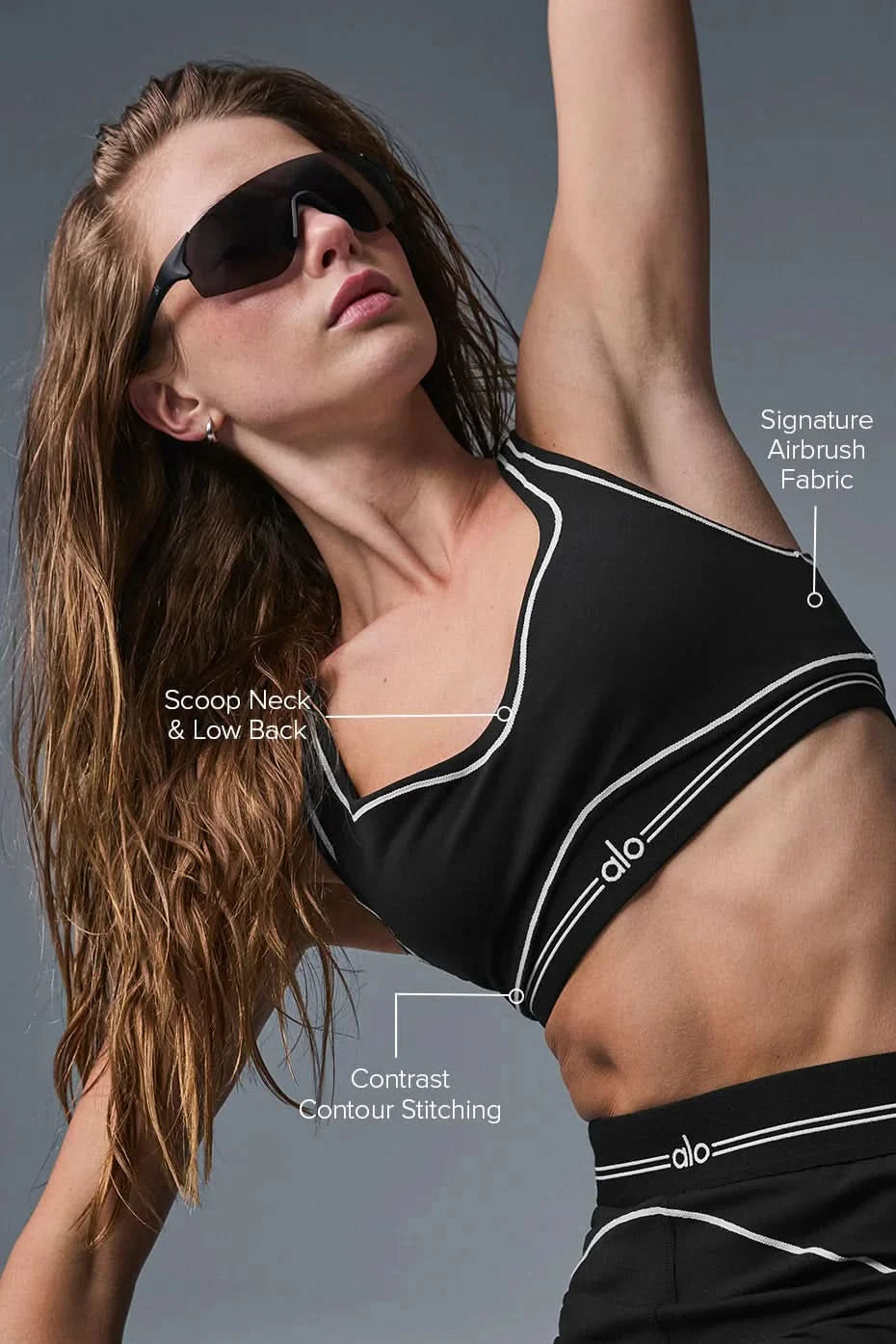 White sports bra and leggings set with black contrast stitching and striped waistband