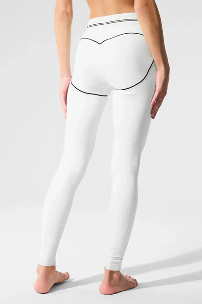 White sculpting leggings back view with black curved seam lines and contour detail