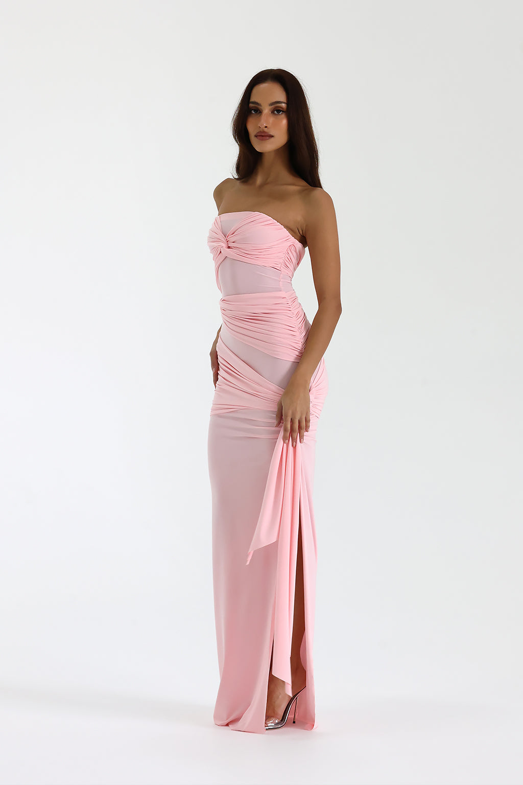 Side view of pink formal maxi dress with ruched details and side tie accent