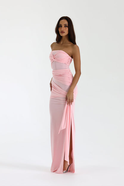 Side view of pink formal maxi dress with ruched details and side tie accent