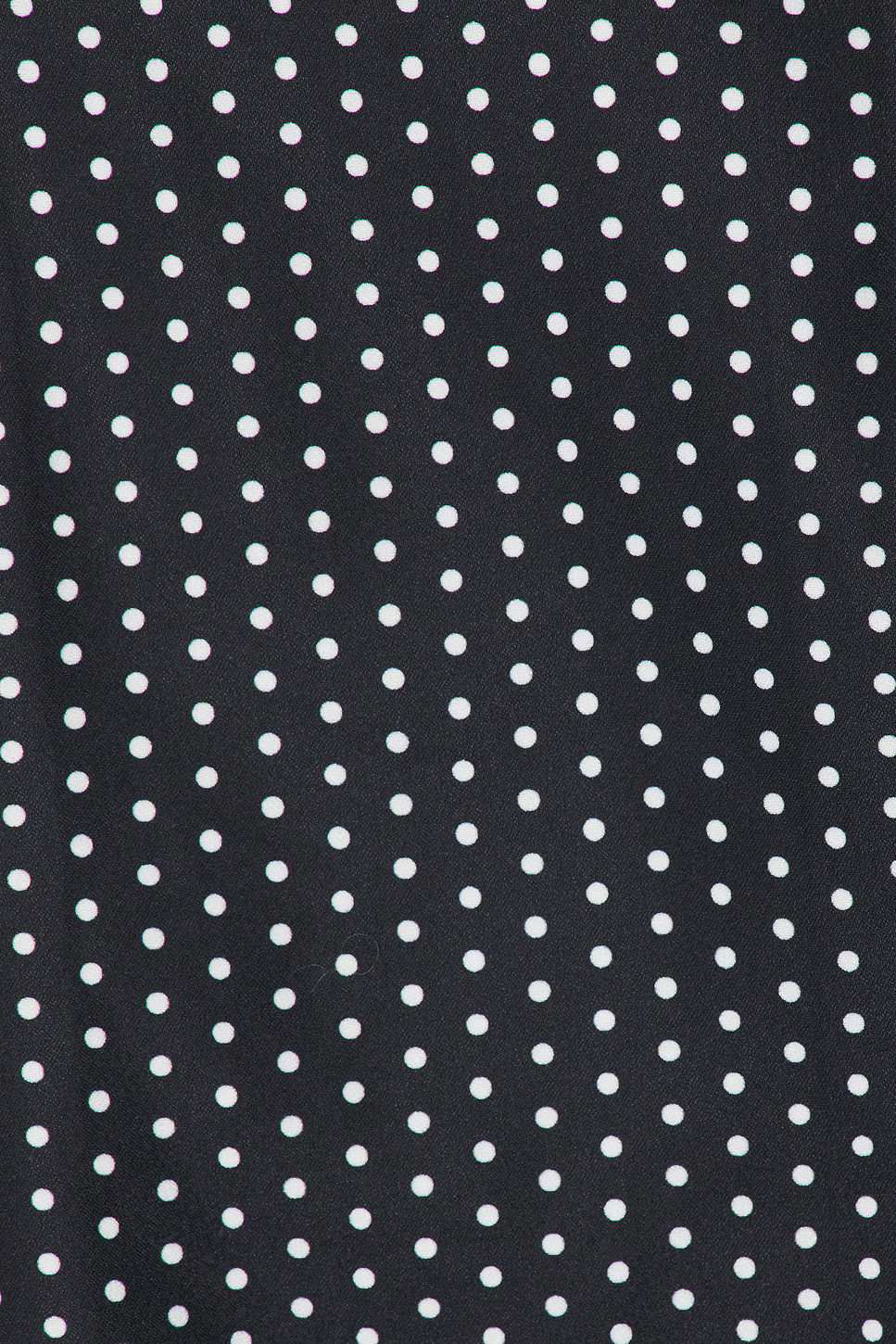 Close-up of black crepe fabric with white polka dot pattern detail