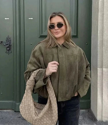 Olive suede loose jacket worn with black jeans and cream woven bag