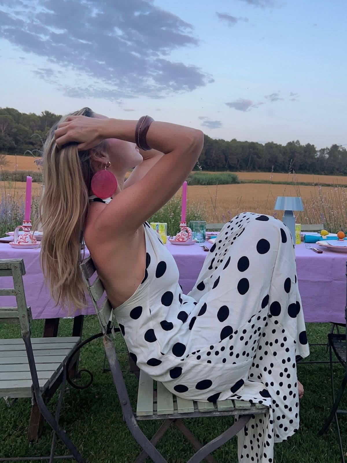 White polka dot backless maxi dress with open back at outdoor event