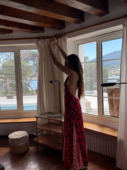 Back view of red floral maxi dress showing open backless design