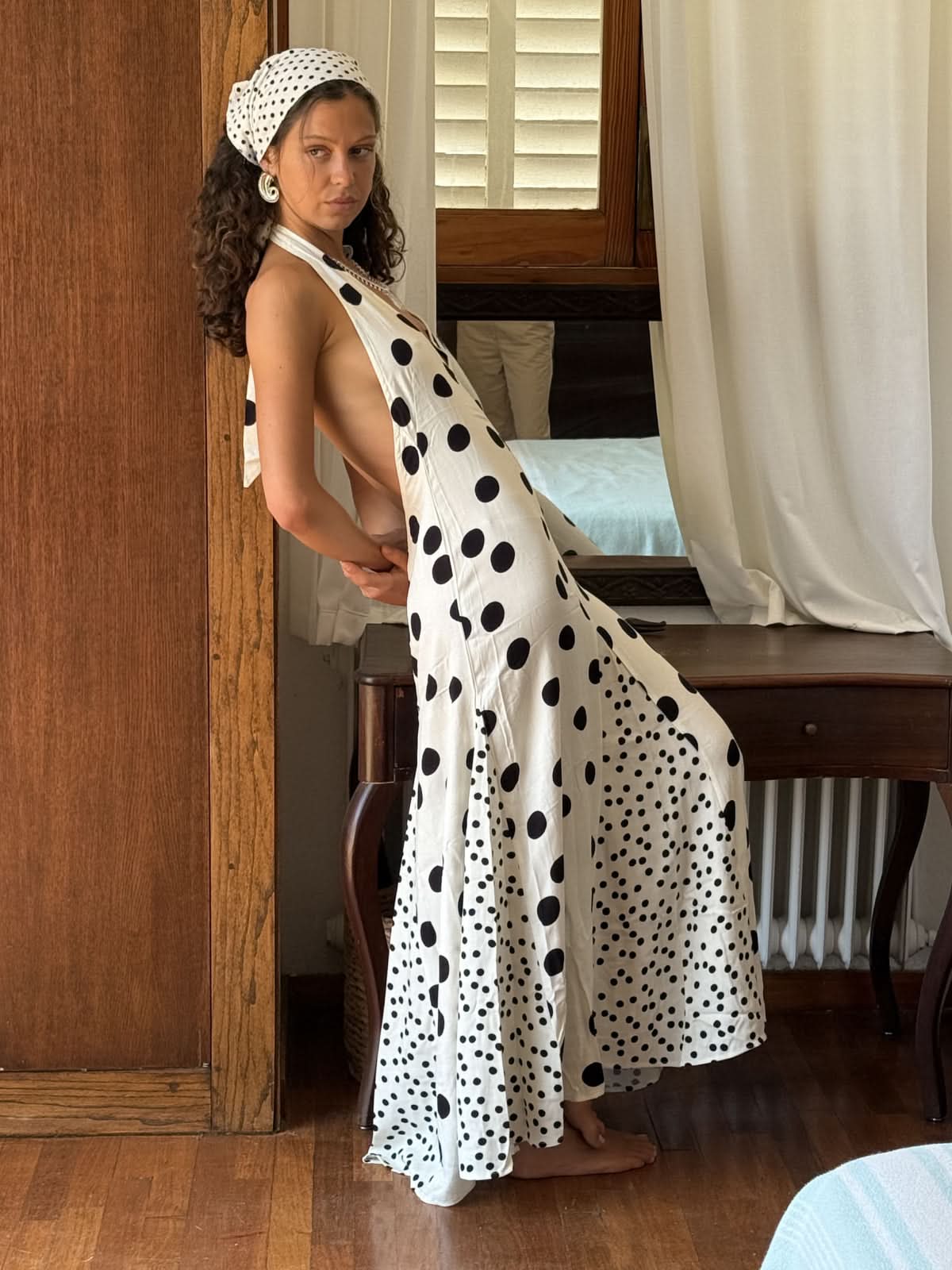 Back view of red floral maxi dress showing open backless design