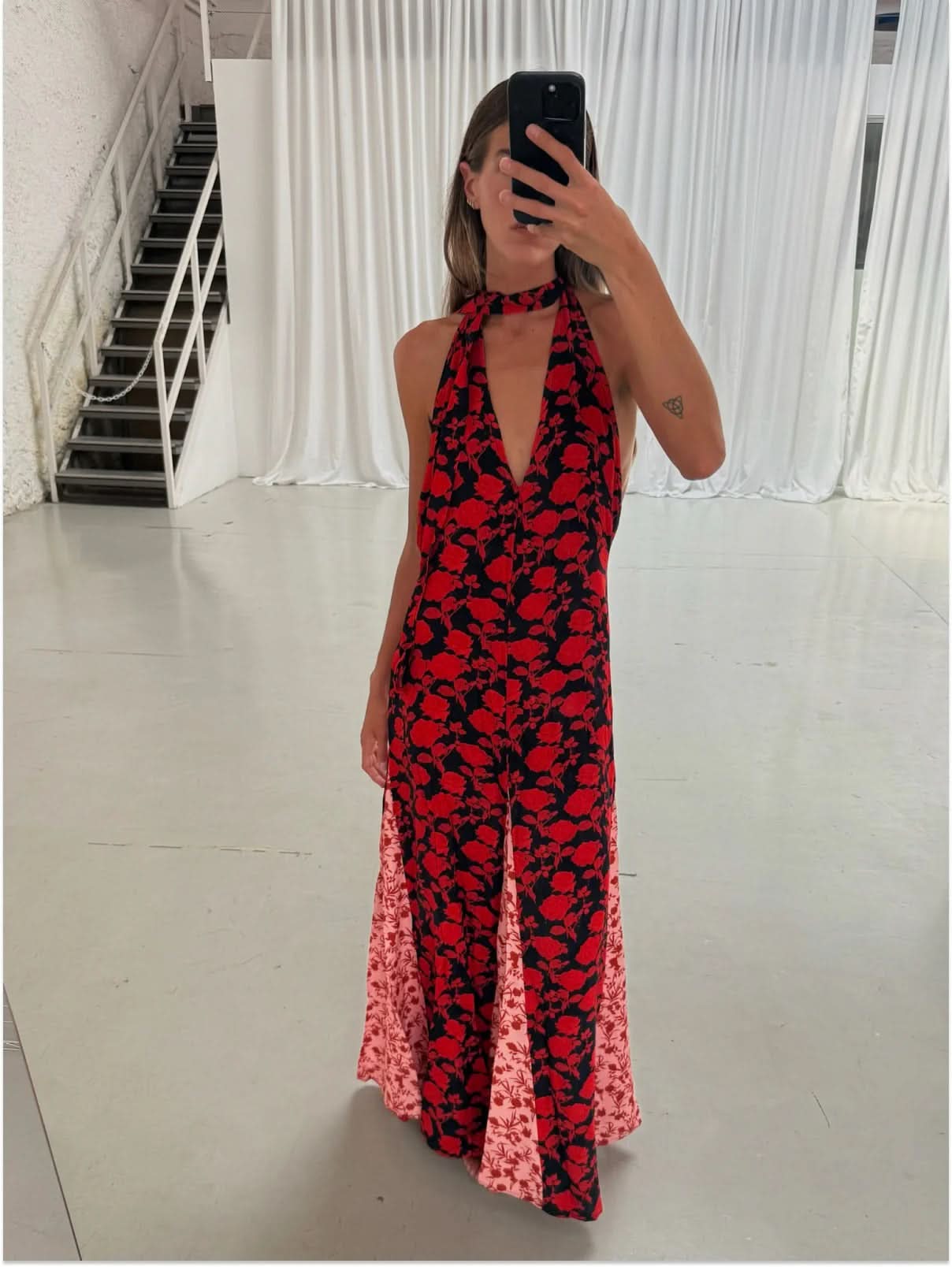 Red and black floral halter maxi dress with backless design and flowing skirt
