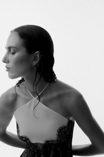 Profile portrait showing halter neckline and black lace bodice of maxi dress