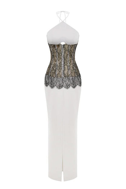 Back view of white maxi dress with black lace waist detail and front slit