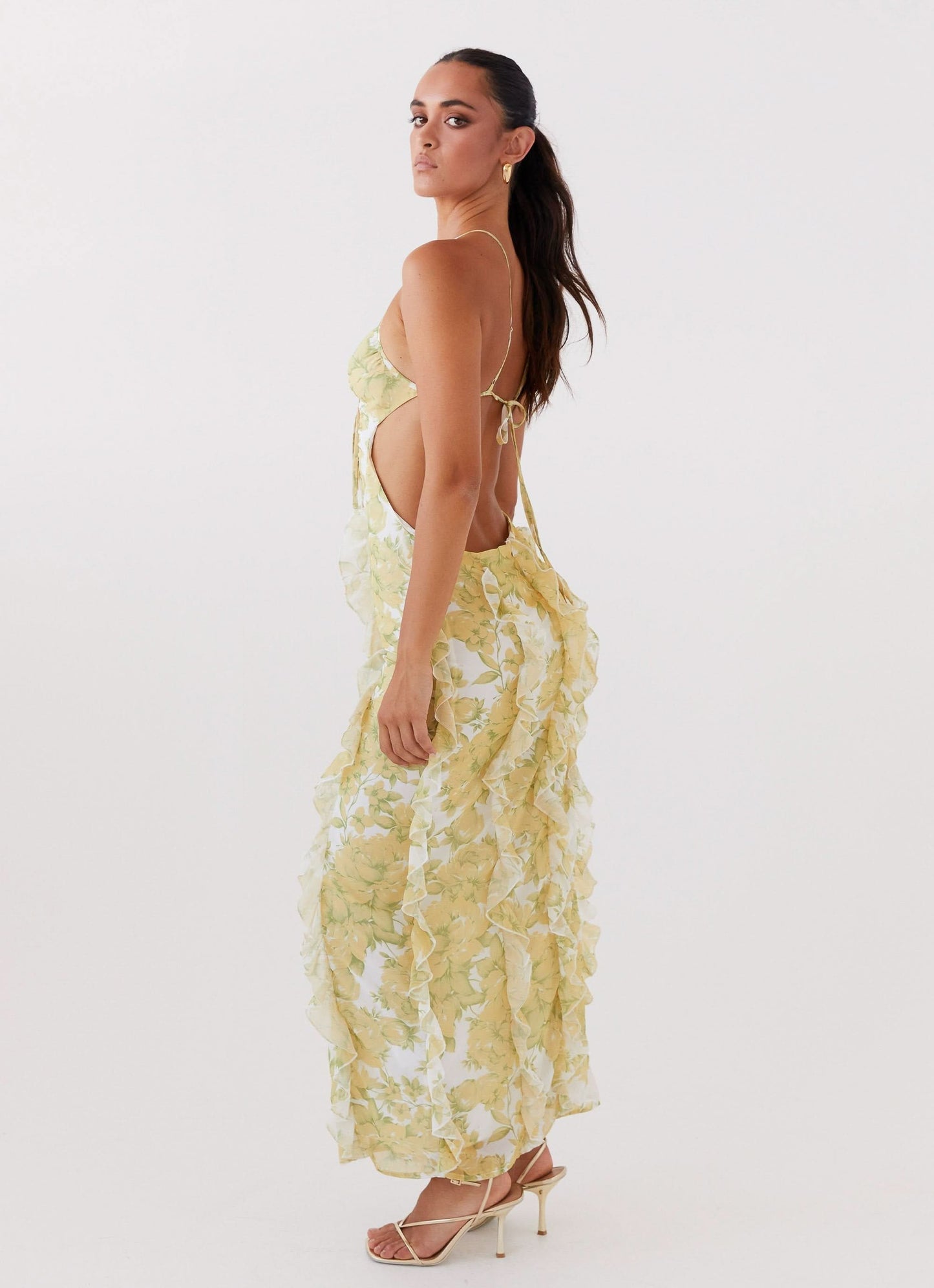 Yellow floral maxi dress with open back and cascading ruffle detailing for women