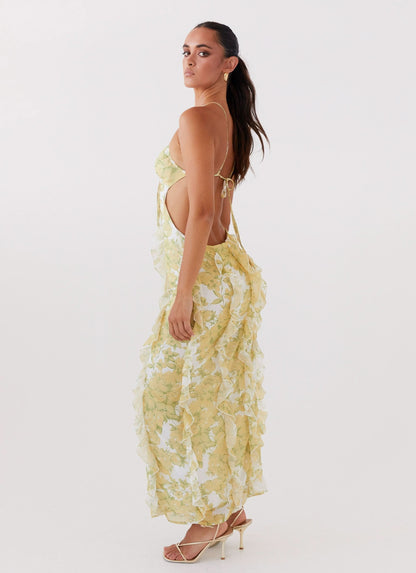 Yellow floral maxi dress with open back and cascading ruffle detailing for women