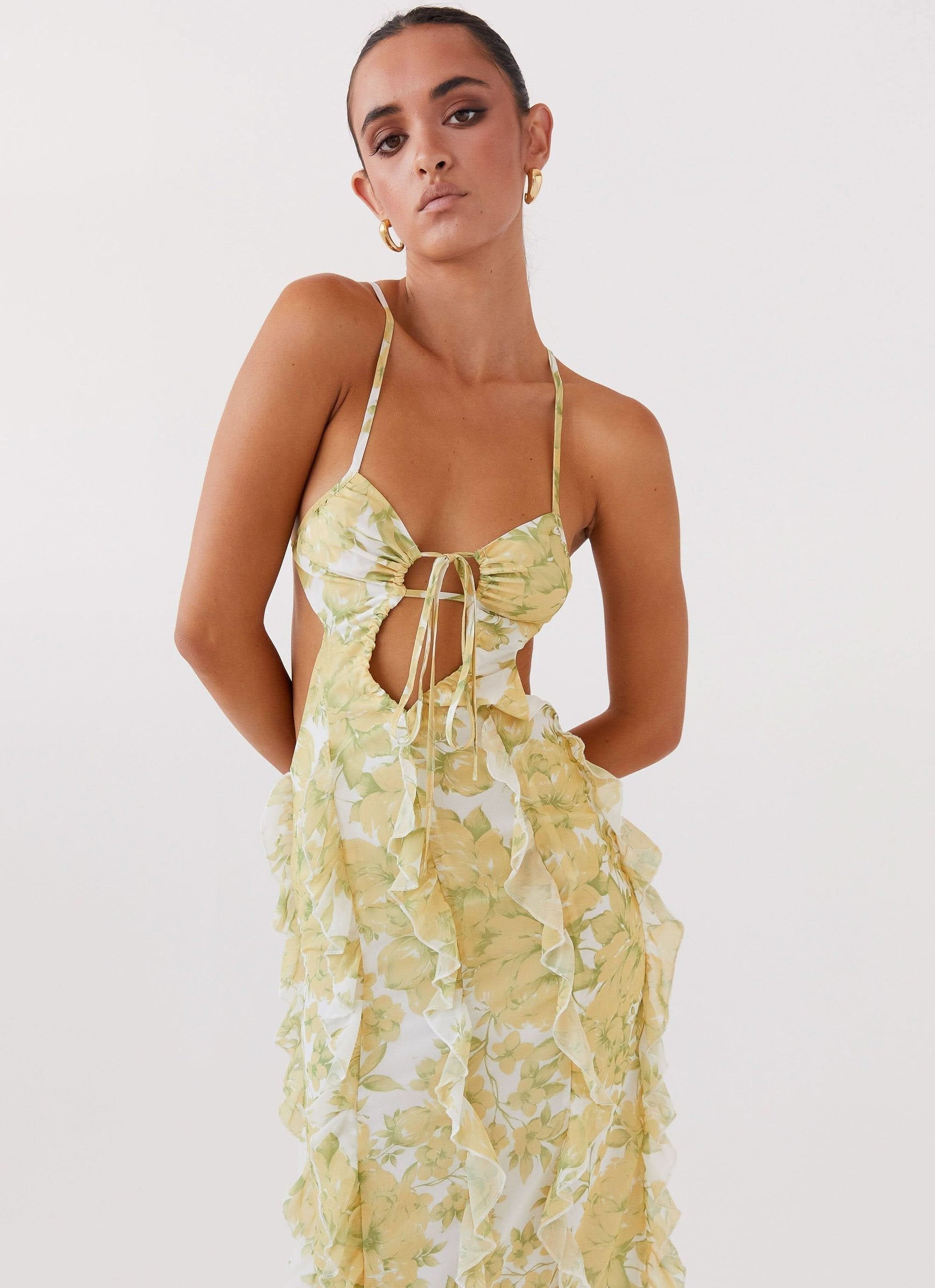Yellow floral ruffle maxi dress with bow cut-out and open back design for women