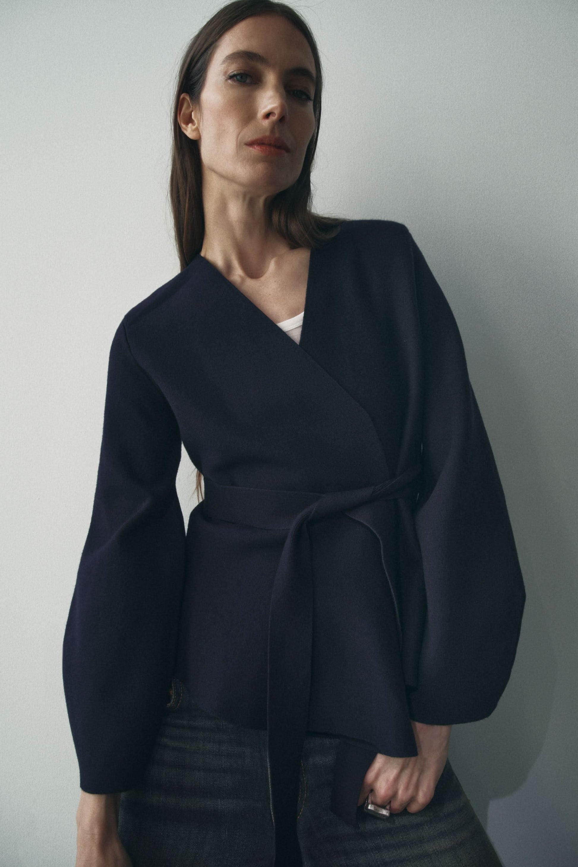 Navy wrap cardigan with long sleeves and tie waist closure