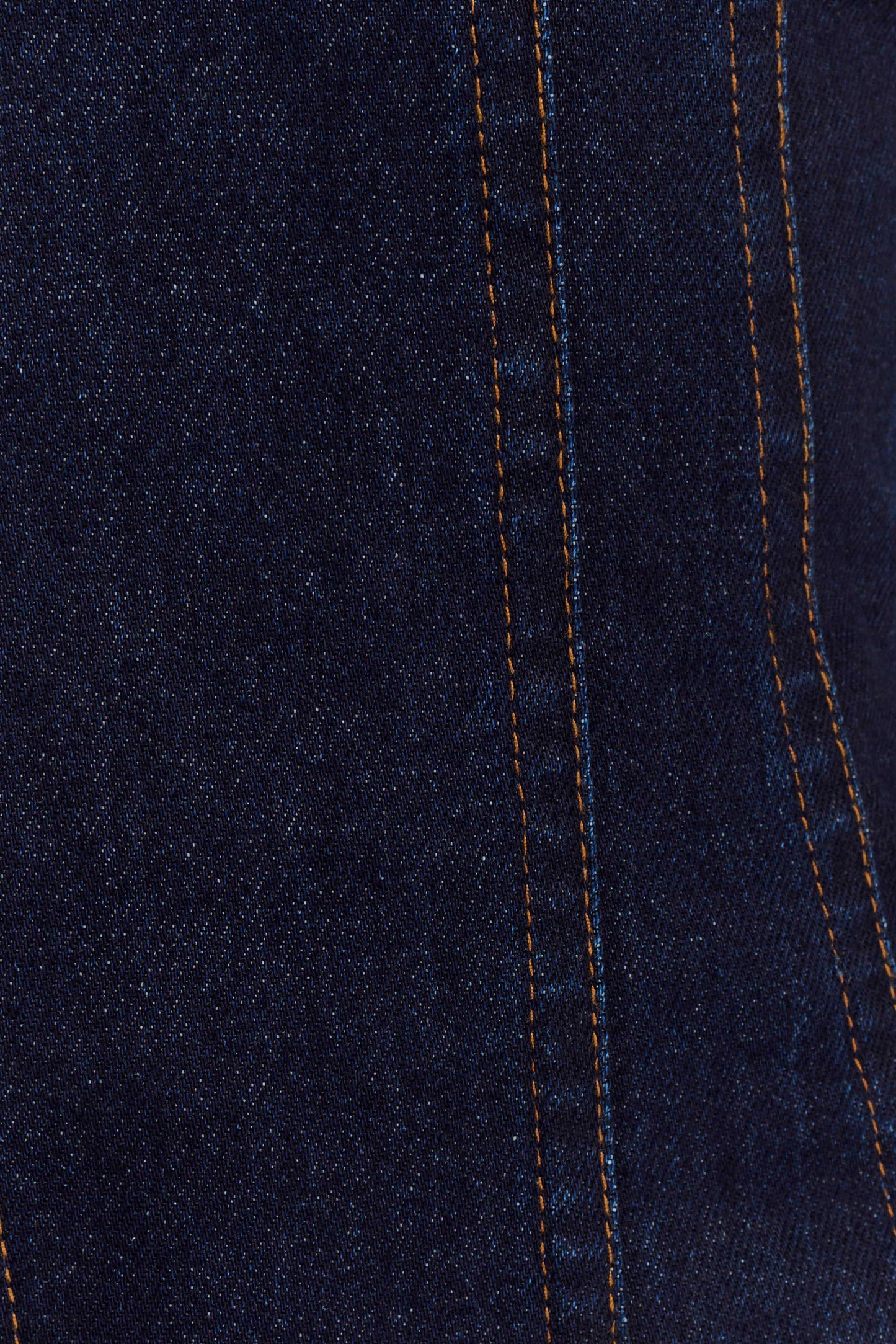 Dark indigo denim fabric close-up showing contrast orange stitching detail
