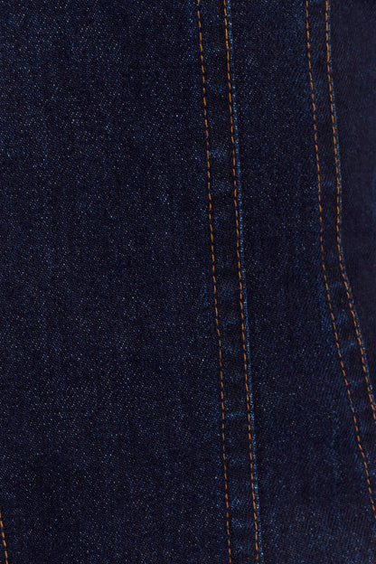 Dark indigo denim fabric close-up showing contrast orange stitching detail