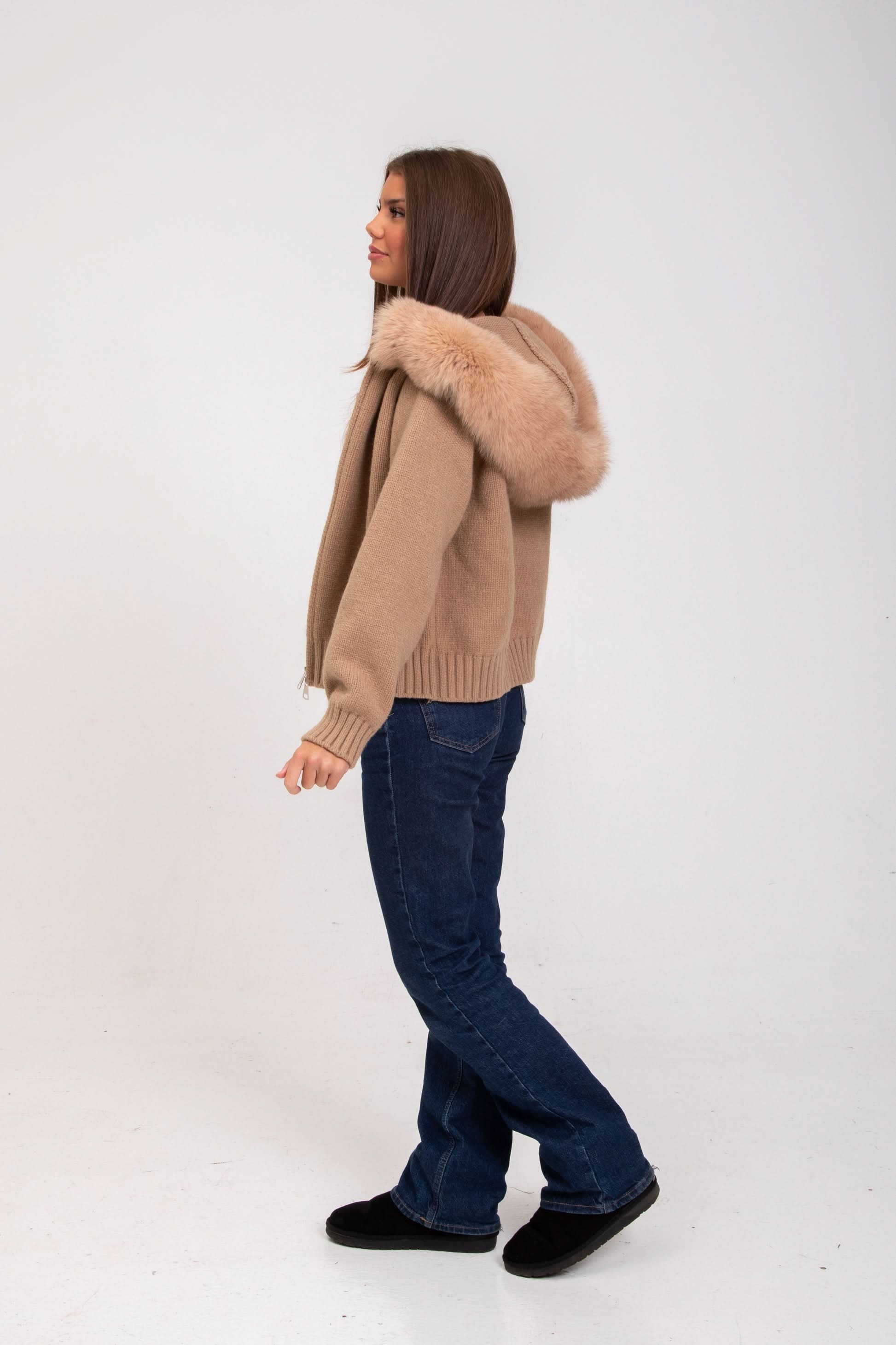 Tan knit cardigan with fur hood, side profile view