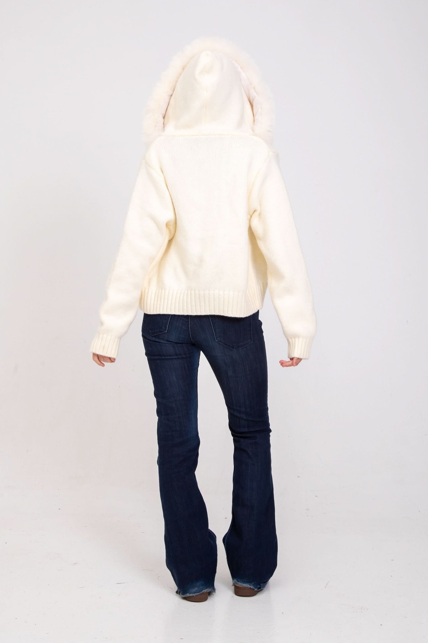 Cream knit cardigan with fur-lined hood, back view
