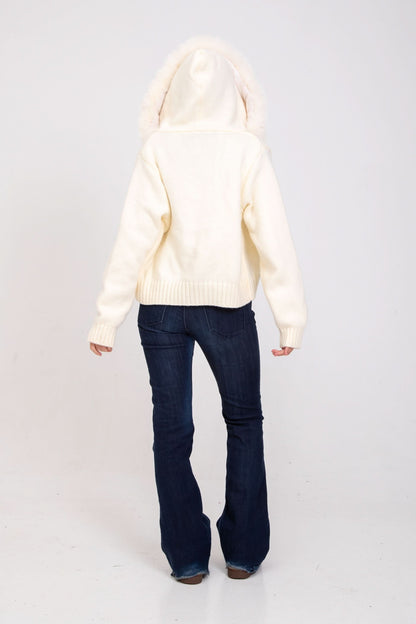 Cream knit cardigan with fur-lined hood, back view